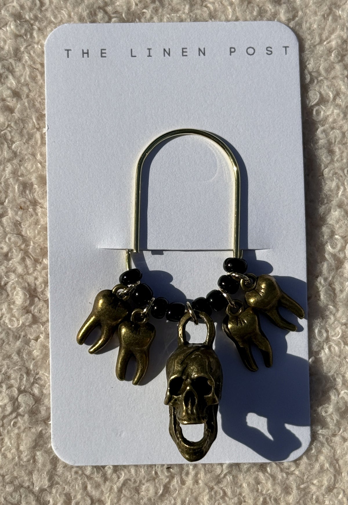 Bronze Skull & Teeth Planner Clip on a The Linen Post card