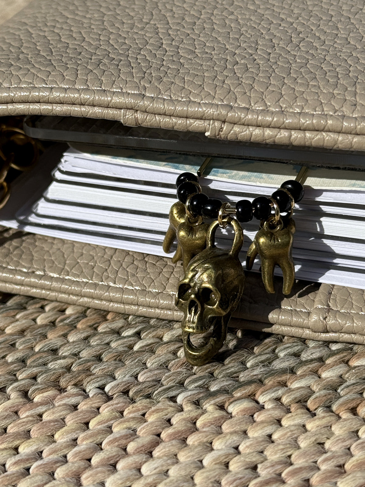 Bronze Skull & Teeth Planner Clip clipped onto a planner