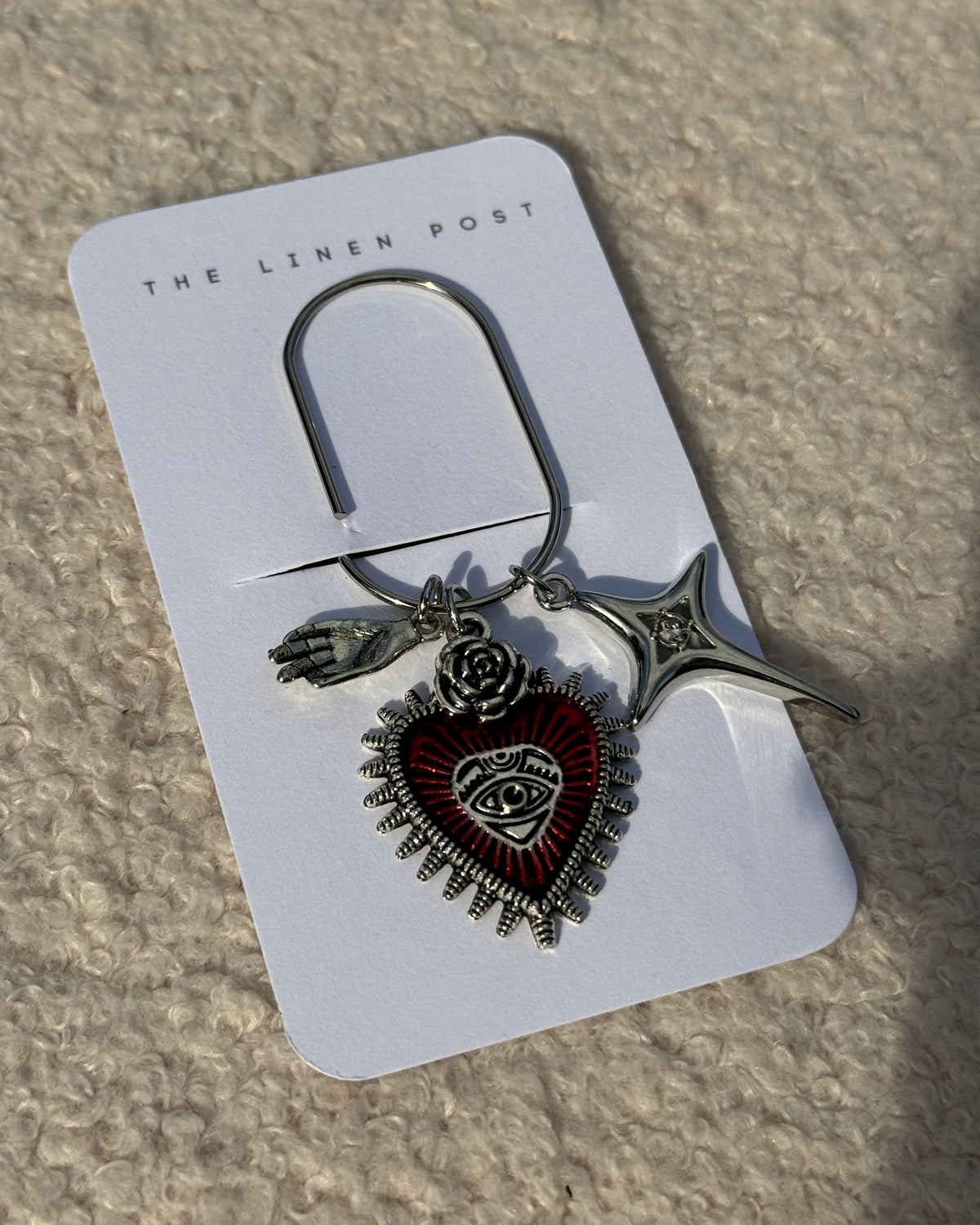 Close-up of the Red Sacred Heart & Star Planner Clip charms on its card