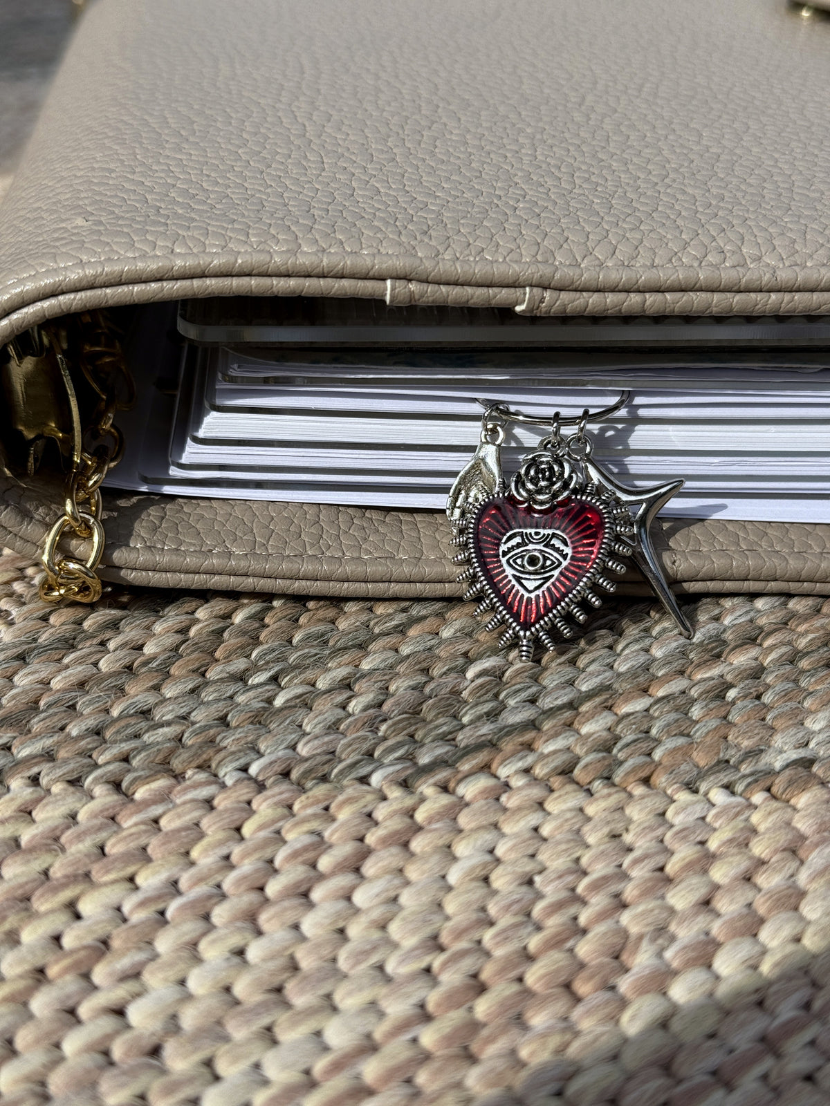 Red Sacred Heart & Star Planner Clip clipped onto a planner page