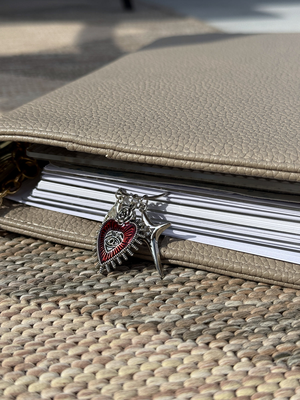 Red Sacred Heart & Star Planner Clip marking a page in a planner