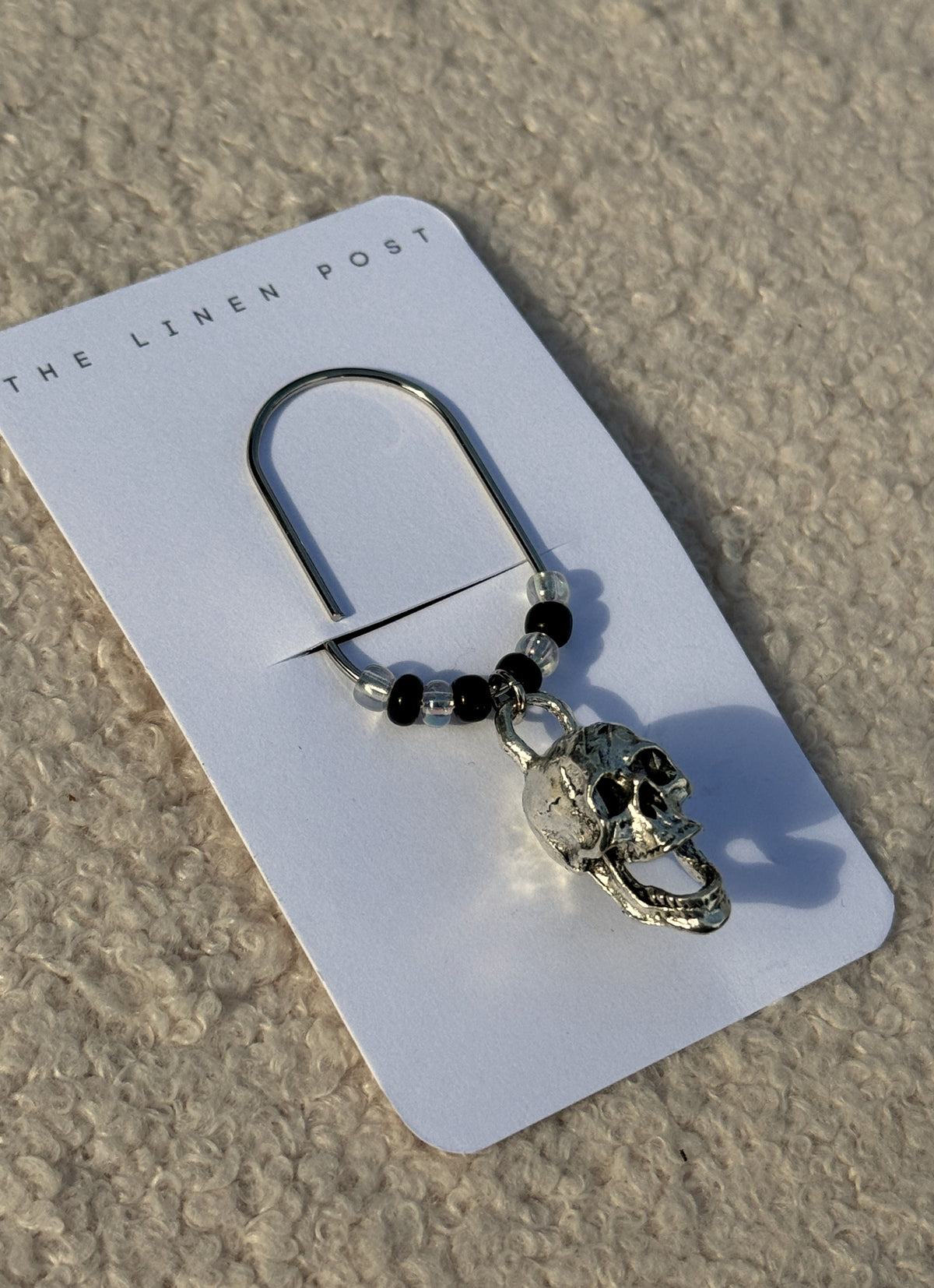 Silver Skull & Black Bead Planner Clip at an angle on its card