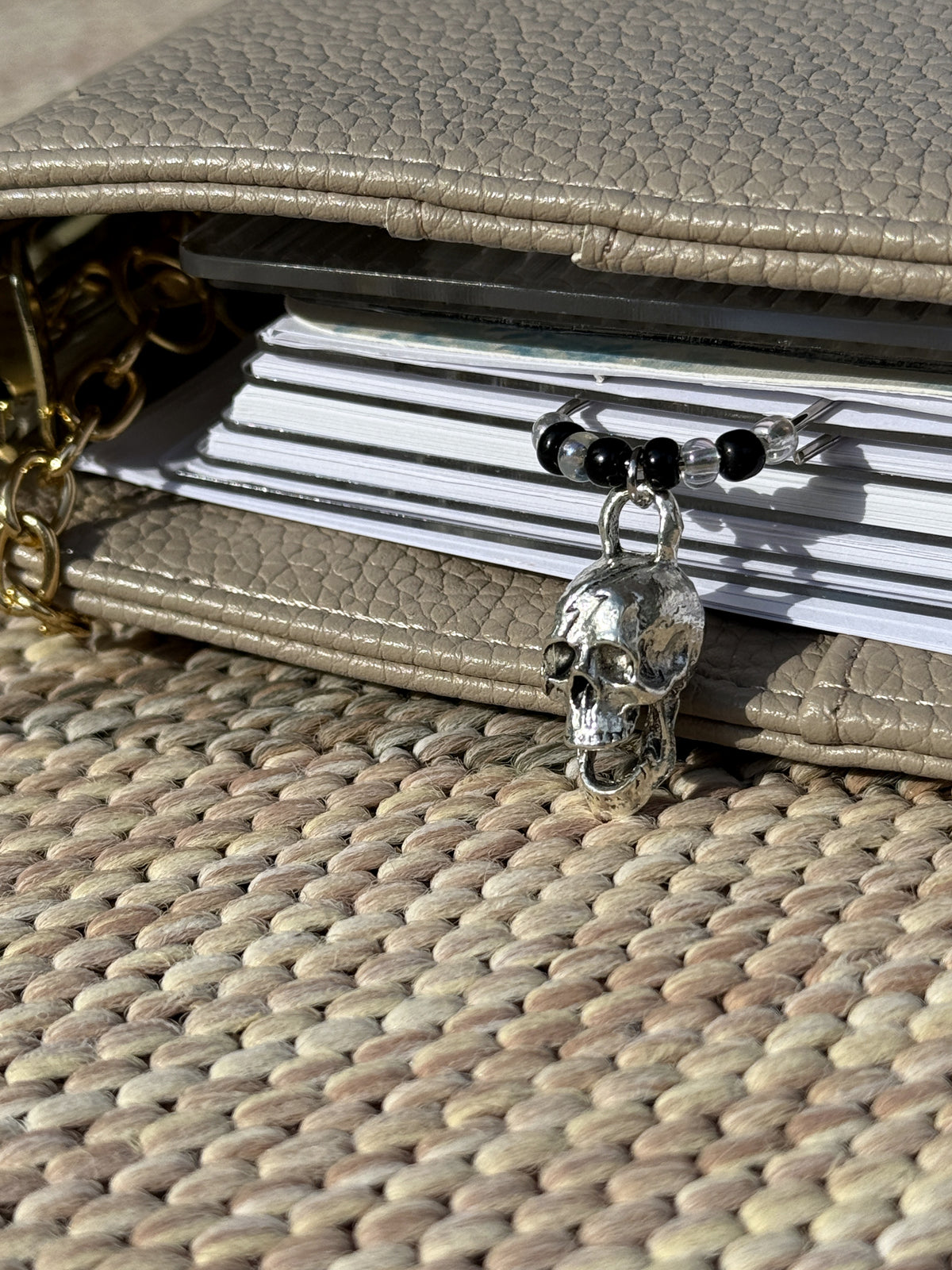 Silver Skull & Black Bead Planner Clip clipped onto a planner