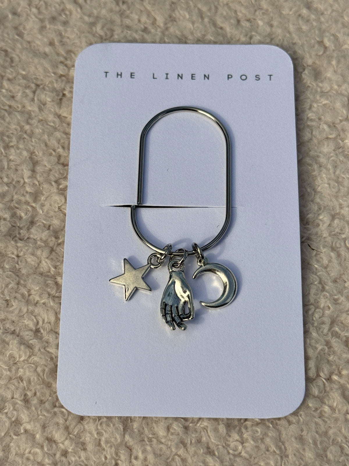 Front view of the Star Hand & Moon Planner Clip on its card