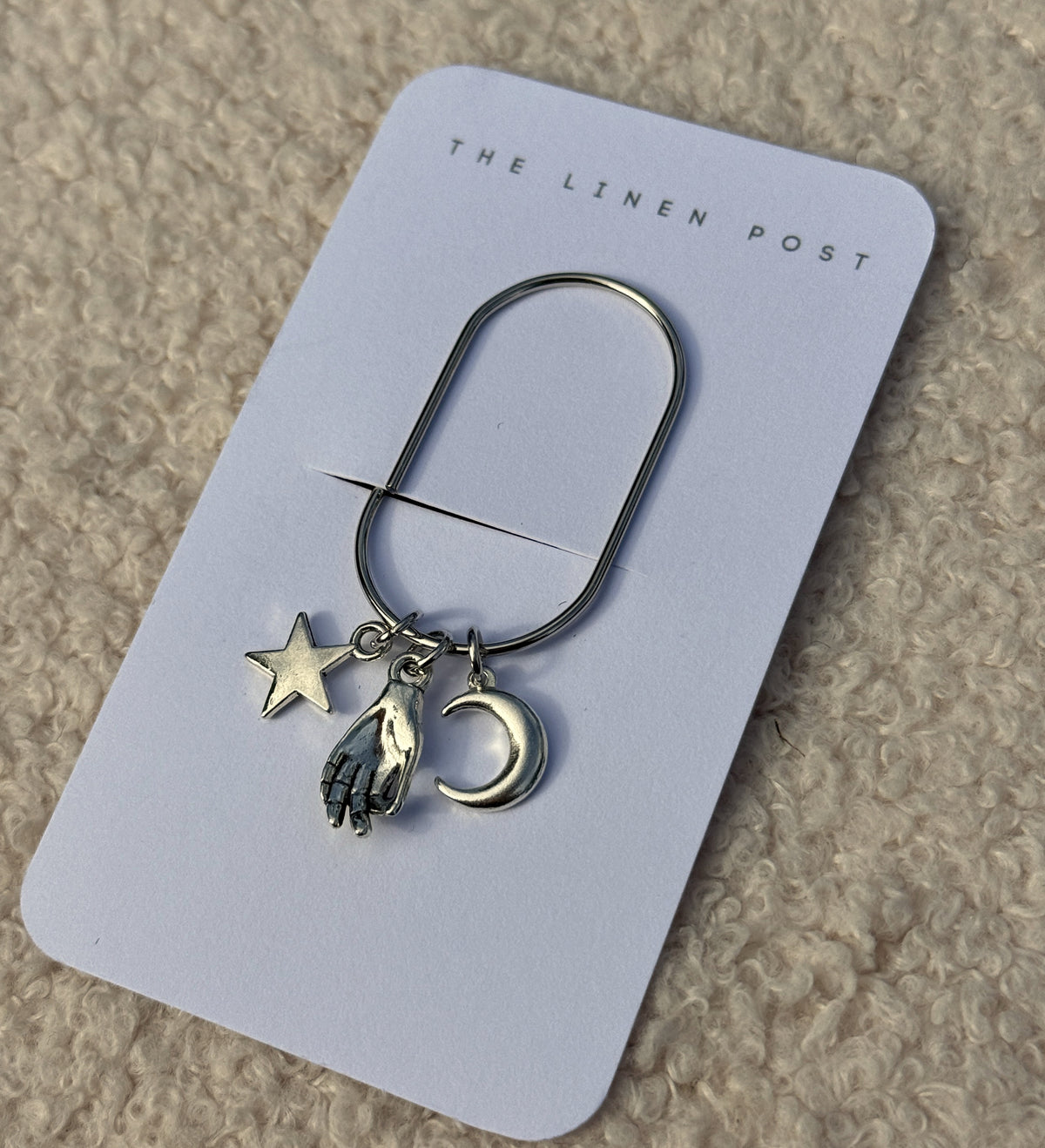 Star Hand & Moon Planner Clip at an angle on its card