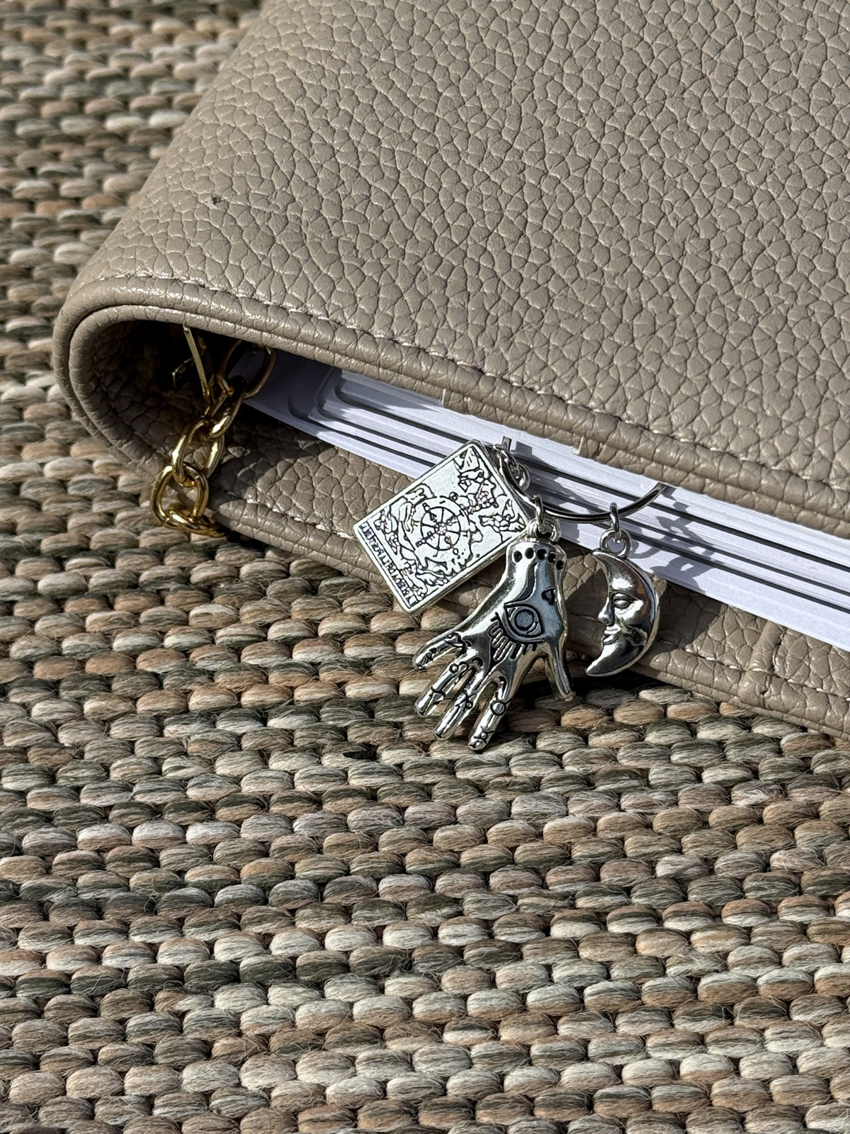 Tarot Hand & Moon Planner Clip clipped onto a planner