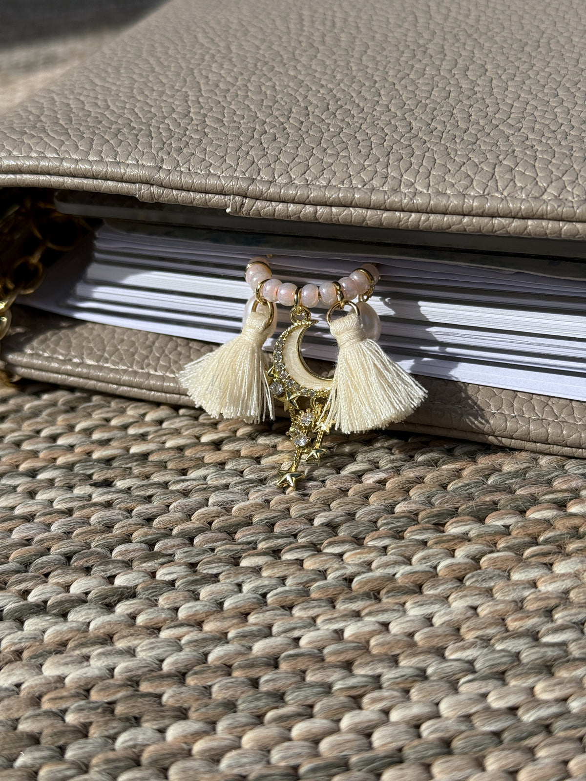 Tassel Moon & Star Planner Clip clipped onto a planner page