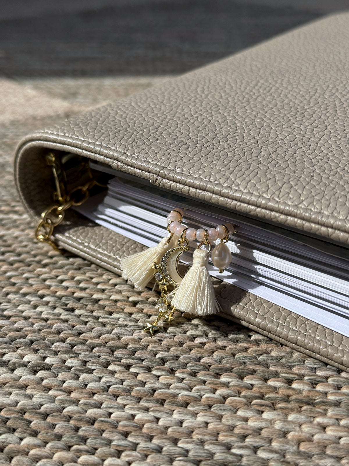 Side view of the Tassel Moon & Star Planner Clip in a planner